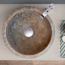 Noce brown travertine natural stone vessel sink surface honed filled size (D)12.5" (H)6" SKU-NTRSTC05 product shot top view installed on above counter with chrome faucet Noce brown travertine natural stone vessel sink surface honed filled size (D)12.5" (H)6" SKU-NTRSTC05 product shot top view installed on above counter with chrome faucet