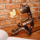 GobekUsa 1-Light Industrial Robot Table Lamp - Antiqued Bronze Metal Nightstand Light for Bedroom
