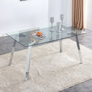 A modern minimalist rectangular glass dining table with tempered glass tabletop and silver metal legs, suitable for kitchens, restaurants, and living rooms,63"x35.4"x30"