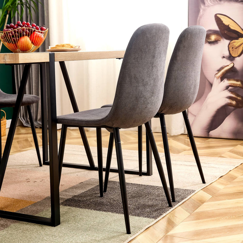 A set of 4 modern medieval style restaurant cushioned side chairs, equipped with soft cushions and black metal legs, suitable for kitchens, lounges, and farmhouses.