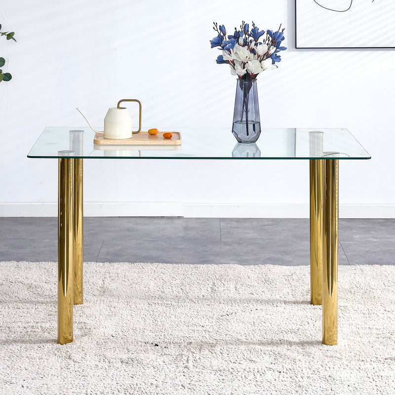 A modern minimalist style glass dining table. Transparent tempered glass tabletop with a thickness of 0.3 feet and golden metal legs. Suitable for restaurants and living rooms. 51"x31.4"x29.5"