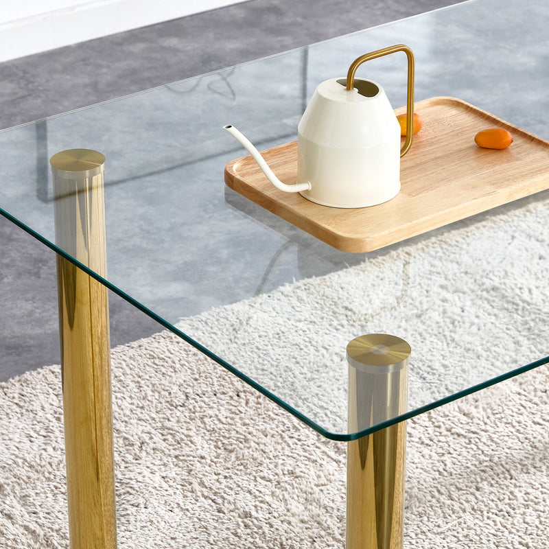 A modern minimalist style glass dining table. Transparent tempered glass tabletop with a thickness of 0.3 feet and golden metal legs. Suitable for restaurants and living rooms. 51"x31.4"x29.5"