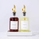 Molimoli Olive Oil Dispenser Bottle for Kitchen, Coffee Syrup Dispenser w. Weighted Pourer, Glass Bottle Dispenser for Kitchen with Ceramic Tray | Gold, 350ml, Set of 2 by CozyNest Decor