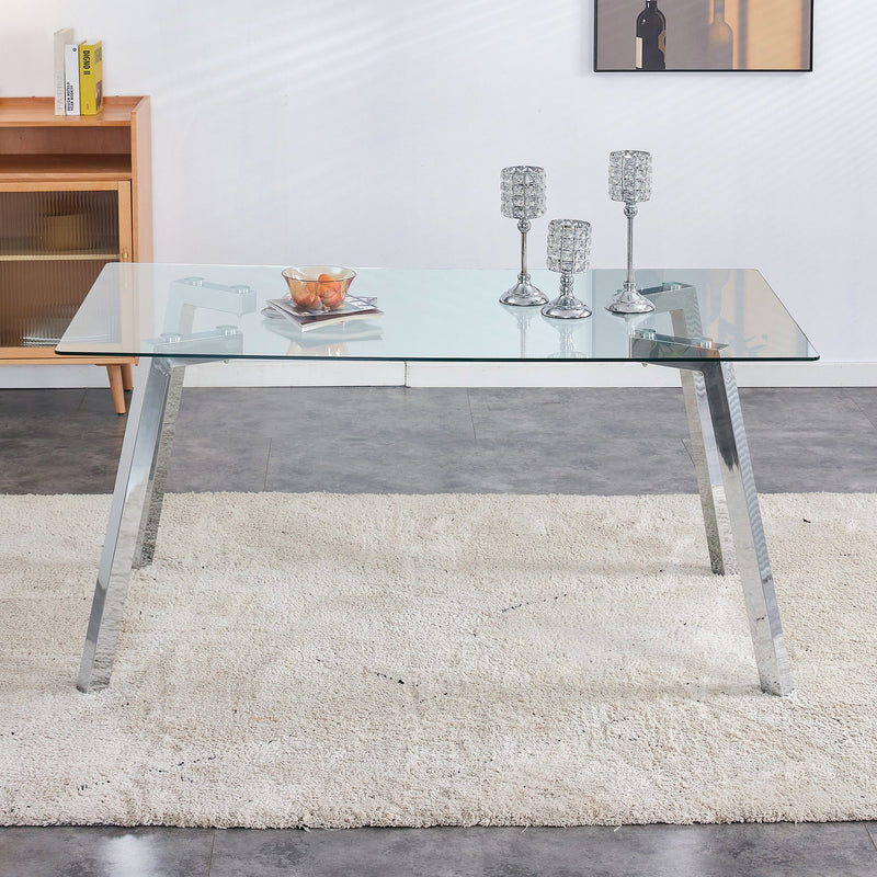 A modern minimalist rectangular glass dining table with tempered glass tabletop and silver metal legs, suitable for kitchens, restaurants, and living rooms,63"x35.4"x30"