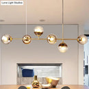 GobekUsa 6-Light Linear Dining Room Island Pendant with Postmodern Metallic Finish and Glass Ball Shades