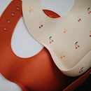 mushie Silicone Baby Bib | Adjustable Fit Waterproof Bibs (Cherries) by TinyTreasures Baby Boutique