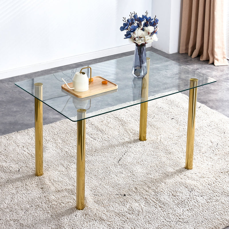 A modern minimalist style glass dining table. Transparent tempered glass tabletop with a thickness of 0.3 feet and golden metal legs. Suitable for restaurants and living rooms. 51"x31.4"x29.5"