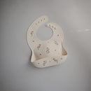 mushie Silicone Baby Bib | Adjustable Fit Waterproof Bibs (Pink Flowers) by TinyTreasures Baby Boutique