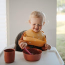 mushie Silicone Baby Bib | Adjustable Fit Waterproof Bibs (Sun Orange) by TinyTreasures Baby Boutique