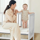 EvoNest Baby Crib, 6 in 1 Convertible Mini Crib with Wheels, 100% New Zealand Solid Wood Growing Bed, 4 Adjustable Mattress Height，White by TinyTreasures Baby Boutique