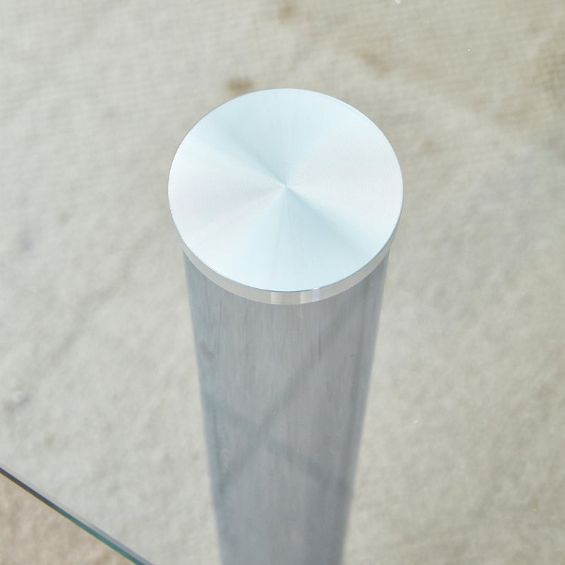 A modern minimalist style glass dining table. Transparent tempered glass tabletop with a thickness of 0.3 feet and silver metal legs. Suitable for restaurants and living rooms. 63 "x 35.4" x 30"
