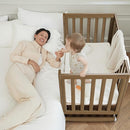EvoNest Baby Crib, 11 in 1 Convertible Mini Crib with Wheels, 100% New Zealand Wood Growing Bed, 4 Adjustable Mattress Height ，Walnut Brown by TinyTreasures Baby Boutique