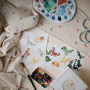 mushie Silicone Baby Bib | Adjustable Fit Waterproof Bibs (Dinosaurs) by TinyTreasures Baby Boutique