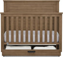 Delta Children Simmons Kids Caden 6-in-1 Convertible Crib with Trundle Drawer, Greenguard Gold Certified, Aged Oak by TinyTreasures Baby Boutique
