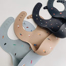 mushie Silicone Baby Bib | Adjustable Fit Waterproof Bibs (Rocket Ship) by TinyTreasures Baby Boutique