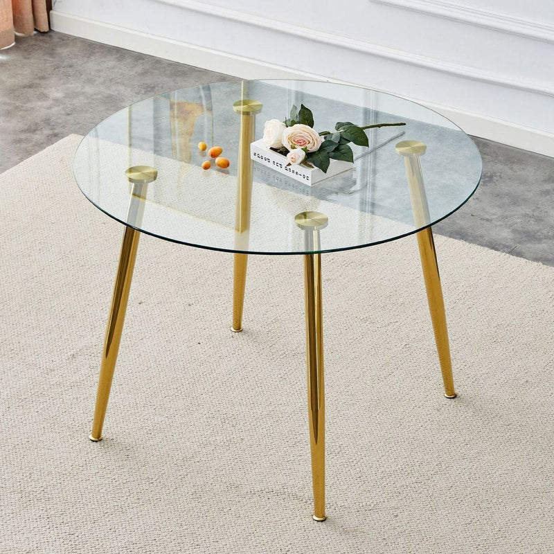 A glass tabletop with a diameter of 40 inches and a modern minimalist circular dining table with gold plated metal legs. 40 'x 40' x 30 ' DT-1164
