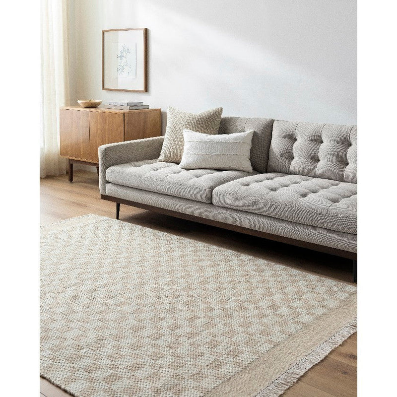 Clinten Solid and Border Tan Area Rug