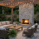Outdoor patio with stone fireplace, seating area, and string lights. Bluestone Marble 3D Ledger Stone Panel 6"x24"