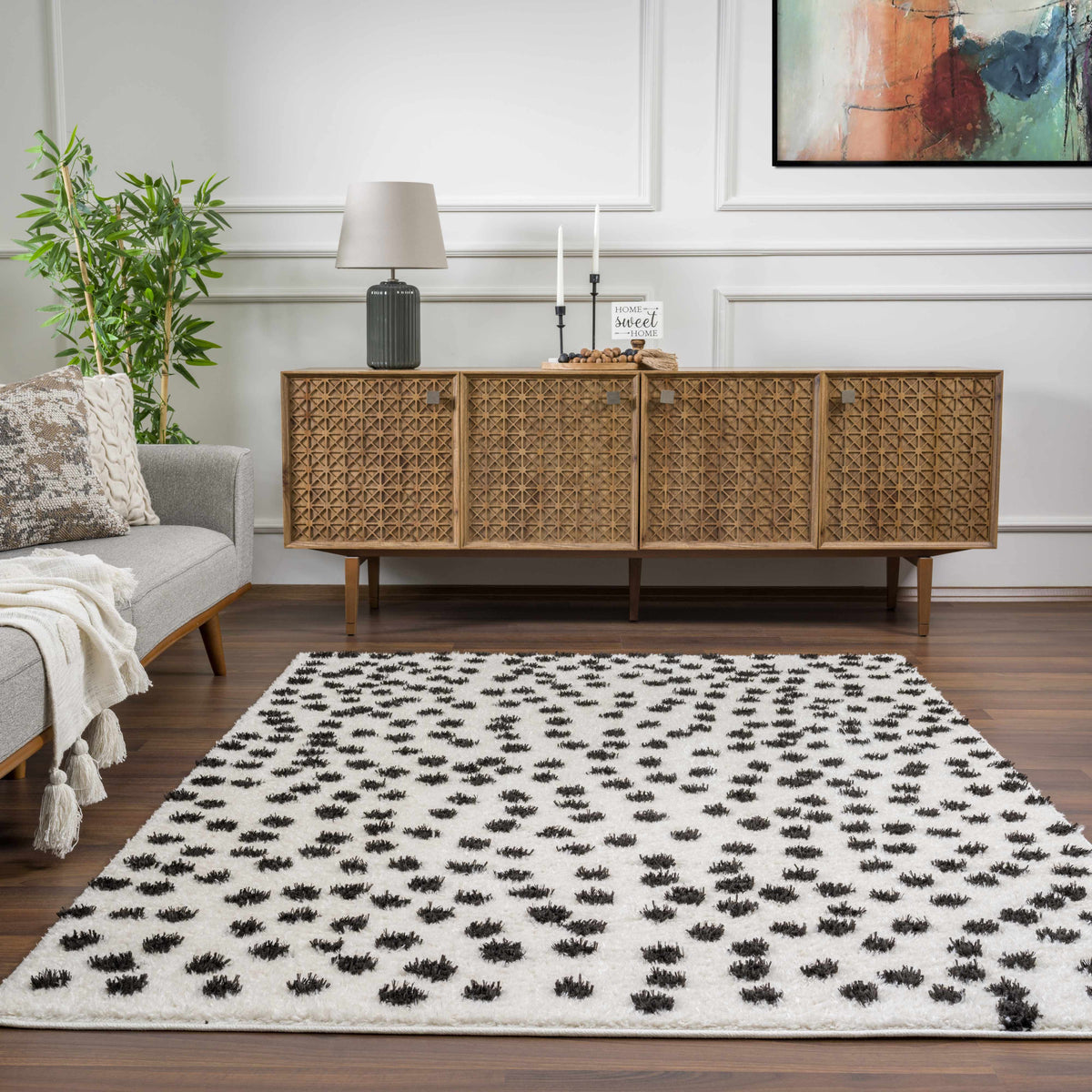 Cansu Black & White Dotted Area Rug, installed in a room