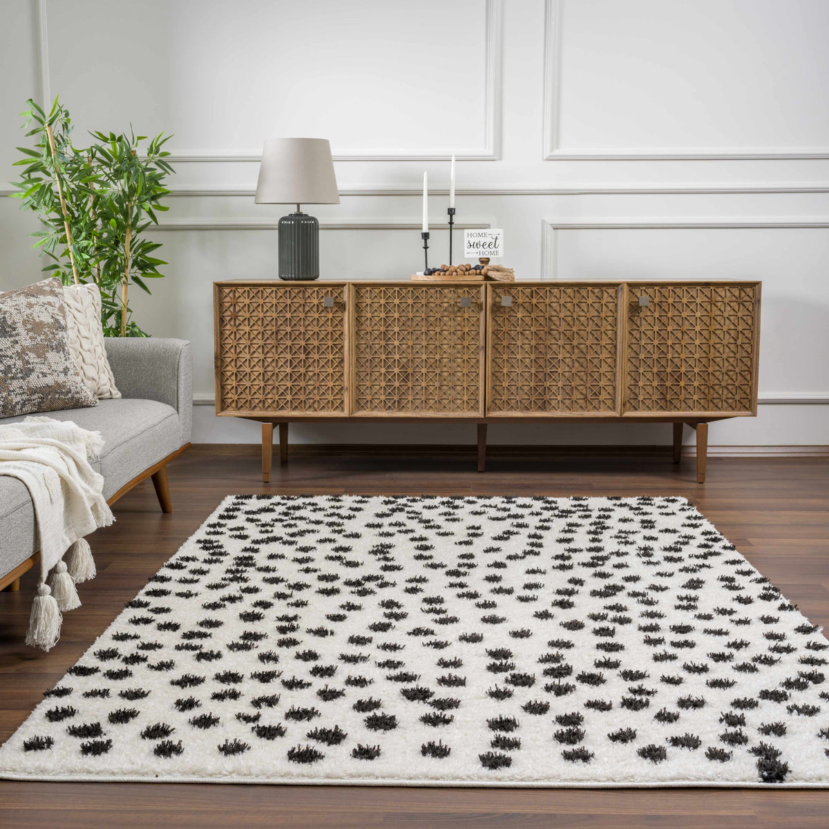 Cansu Black & White Dotted Area Rug, installed in a room