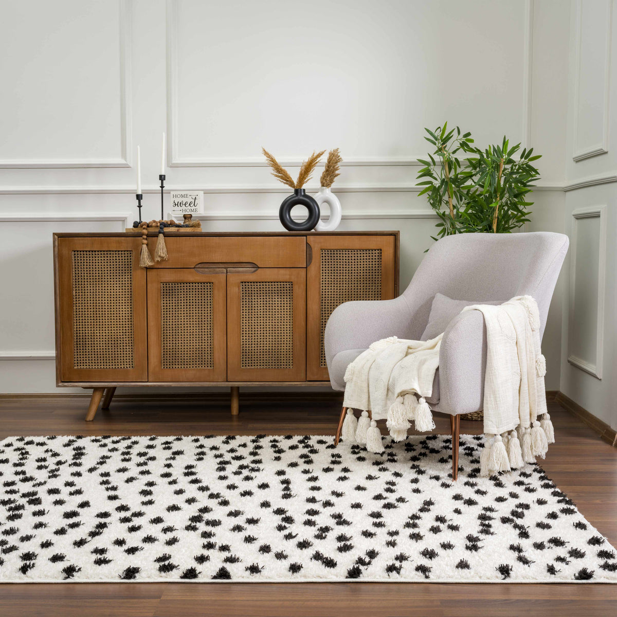Cansu Black & White Dotted Area Rug, installed in a room