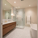 Modern bathroom with wooden vanity, glass shower, and freestanding bathtub. Turkish Carrara Marble 2"x2" on 12" x 12" Mesh Mosaic Tile