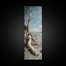 Framed Canvas Print Skinny Art of a Weathered Driftwood Tree Trunk on a Sandy Shore with a Calm Ocean Backdrop, Ideal Tall Art for Coastal Decor