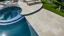 Pool area with tiled pool and stone patio