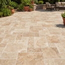 Paved patio with stone tiles, outdoor furniture, and plants in a garden setting.