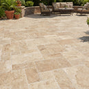 Outdoor patio with stone tiles, furniture, and plants