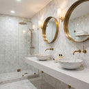 Modern bathroom with marble tiles, gold fixtures, and round mirrors. Palia White Dolomite Dimensional Mosaic Tile Stella Design on 12" x 12" Mesh