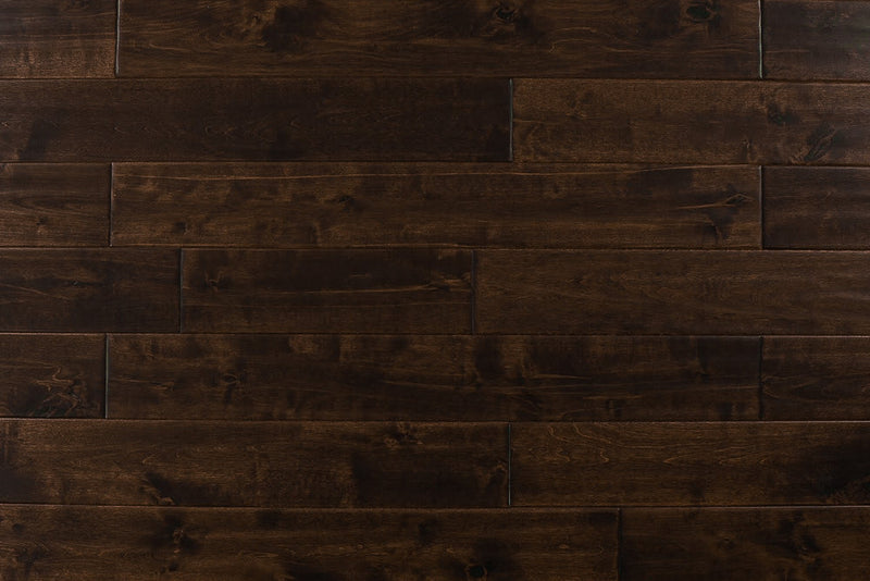 Close-up of Maple Distressed/Handscraped Solid Hardwood Flooring Planks, 3/4 x 5 inches, in a rich Walnut finish, showcasing its natural texture and warmth.