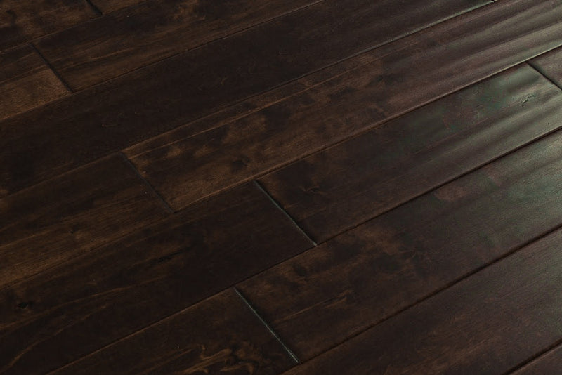 Close-up of Maple Distressed/Handscraped Solid Hardwood Flooring Planks, 3/4 x 5 inches, in a rich Walnut finish, showcasing its natural texture and warmth.