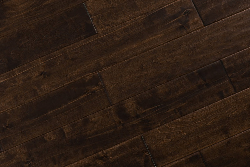 Close-up of Maple Distressed/Handscraped Solid Hardwood Flooring Planks, 3/4 x 5 inches, in a rich Walnut finish, showcasing its natural texture and warmth.