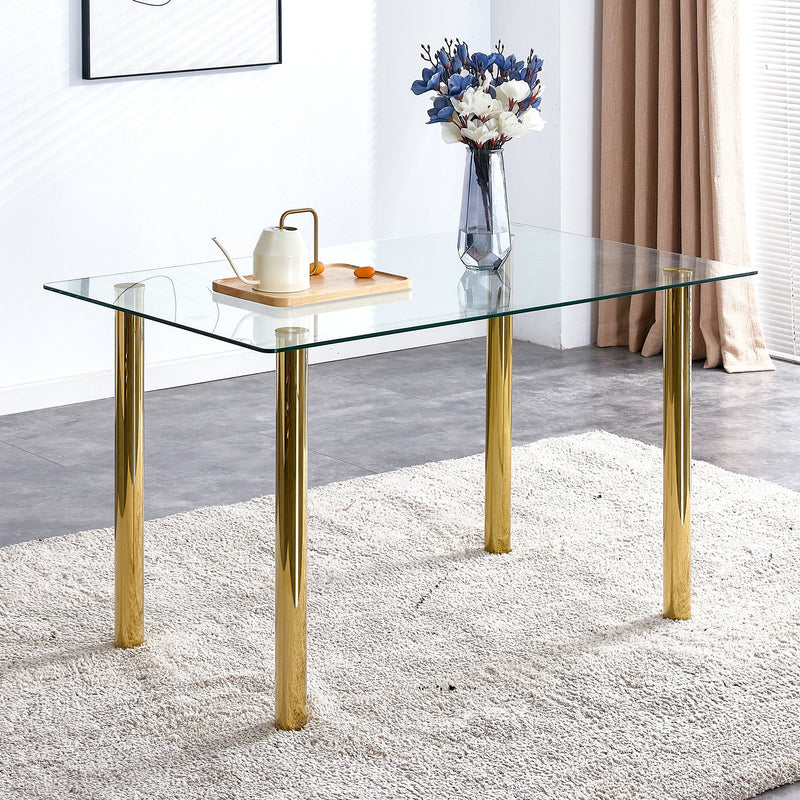 A modern minimalist style glass dining table. Transparent tempered glass tabletop with a thickness of 0.3 feet and golden metal legs. Suitable for restaurants and living rooms. 51"x31.4"x29.5"