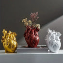 White anatomical heart vase with colorful flowers for living room by Decorbites