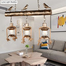 GobekUsa Antique Brass Lantern Pendant with Clear Glass and Bird Accent - 3-Light Coastal Island Kit