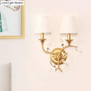 GobekUsa Minimalist Beveled Crystal Wall Mount Lamp with Black/Gold Finish - 2 Bulbs, Conic Fabric Shade