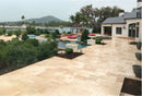 Patio area with a pool and scenic view of mountains and water. Aspendos Tumbled Travertine Pavers
