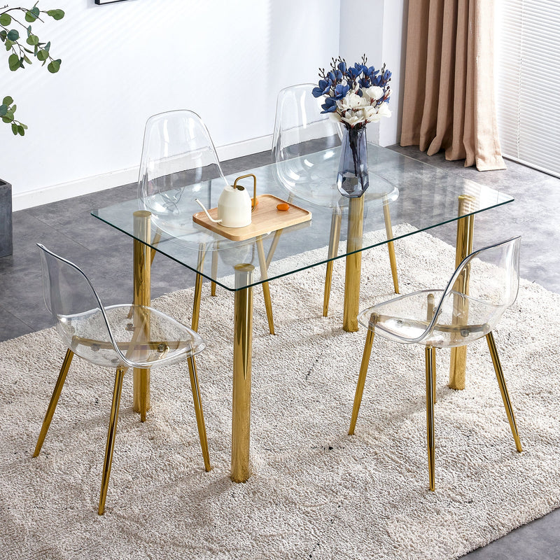 A modern minimalist style glass dining table. Transparent tempered glass tabletop with a thickness of 0.3 feet and golden metal legs. Suitable for restaurants and living rooms. 51"x31.4"x29.5"