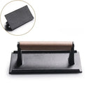 Black and light brown cast iron burger press kitchen meat tool by Decorbites