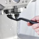 Black plastic coffee machine grinder brush – kitchen cleaning tool by Decorbites