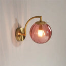 Blue and brass colored glass ball wall lamp for bedroom lighting by Decorbites