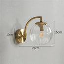 Blue and brass colored glass ball wall lamp for bedroom lighting by Decorbites