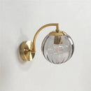 Blue and brass colored glass ball wall lamp for bedroom lighting by Decorbites