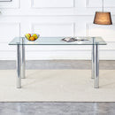 A modern minimalist style glass dining table. Transparent tempered glass tabletop with a thickness of 0.3 feet and silver metal legs. Suitable for restaurants and living rooms. 63 "x 35.4" x 30"