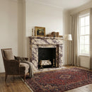 Living room with marble fireplace, armchair, and large window