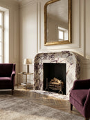 Luxurious living room with marble fireplace, purple armchairs, and a large mirror. Calacatta Viola Marble Modern Fireplace Mantel Polished (L)69" (H)50" (D)6"
