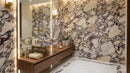 Bathroom with marble walls, wooden vanity, and decorative elements.