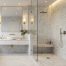 Modern bathroom with marble tiles, a shower, and sink.